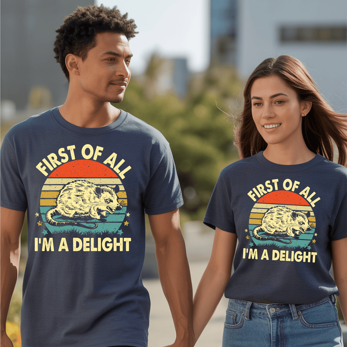 Two models wearing vintage graphic t-shirts with an opossum design and the text "FIRST OF ALL I’M A DELIGHT".
