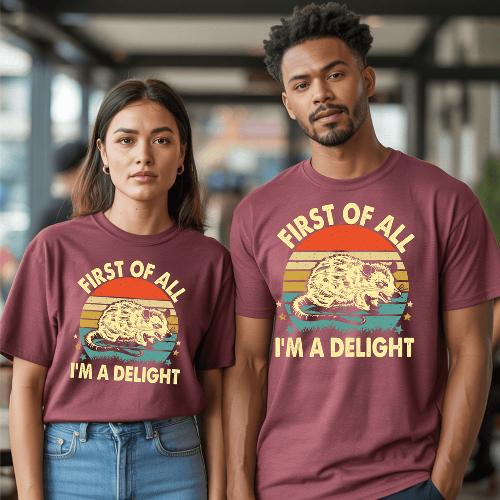 Vintage graphic t-shirt featuring a sunset design and the phrase "FIRST OF ALL I’M A DELIGHT" worn by two models.