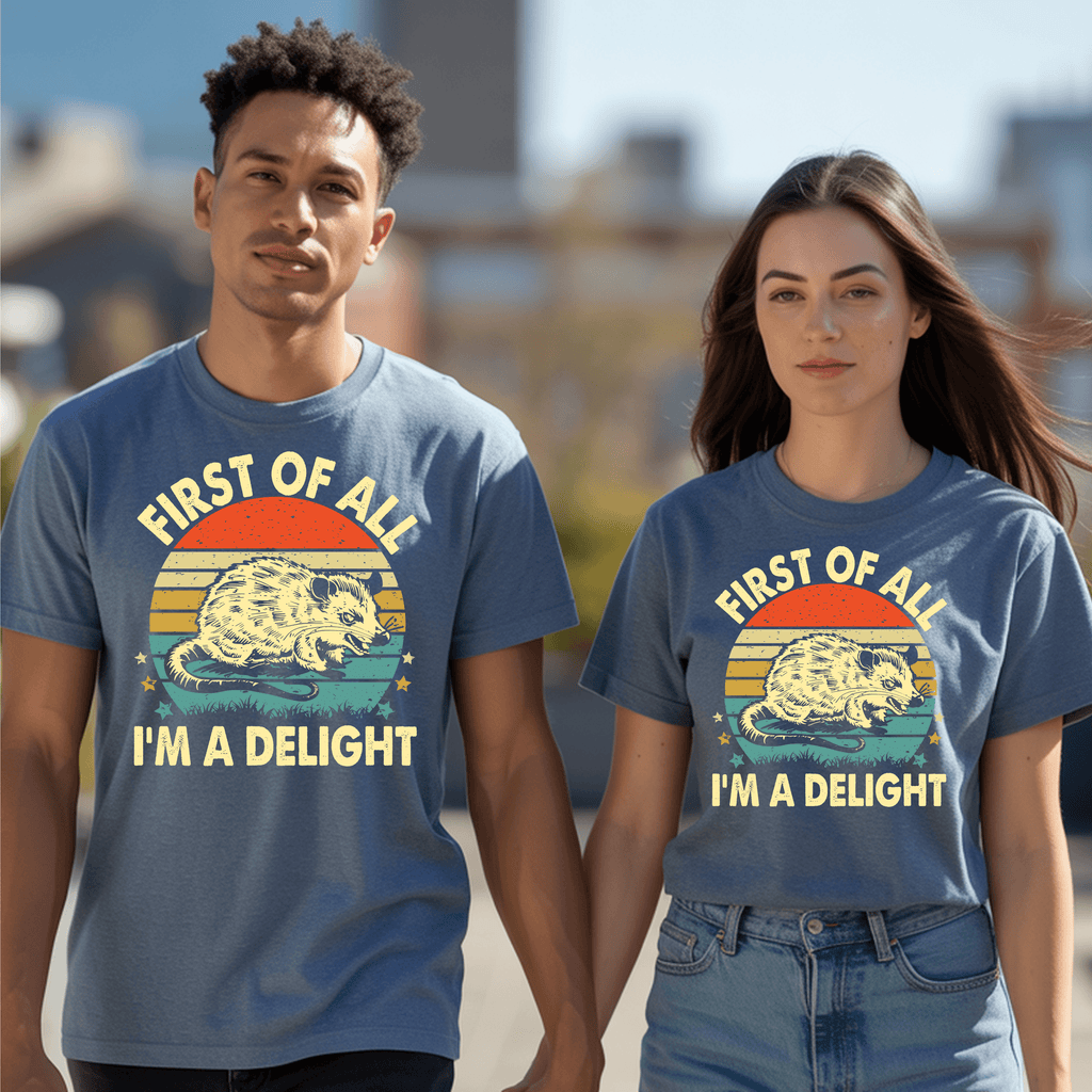 Couple wearing vintage graphic t-shirt featuring an opossum and the phrase "FIRST OF ALL I’M A DELIGHT."