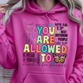 You Are Allowed To Hoodie inspirational affirmation hoodie featuring colorful text and cheerful icons on a pink background