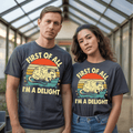 Two people wearing matching graphic t-shirts that say "FIRST OF ALL I’M A DELIGHT" featuring a vintage sunset and opossum design.