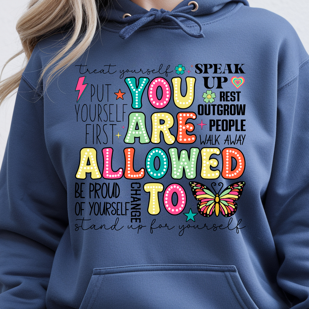 You Are Allowed To Hoodie inspirational affirmation hoodie featuring colorful lettering and cheerful icons on a blue background.