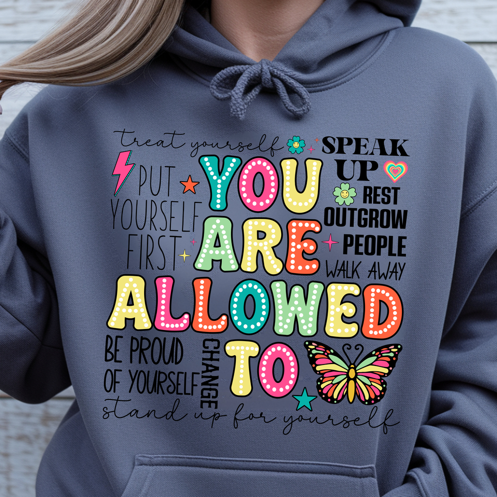 You Are Allowed To Hoodie inspirational affirmation hoodie with colorful lettering and playful icons on a gray background.