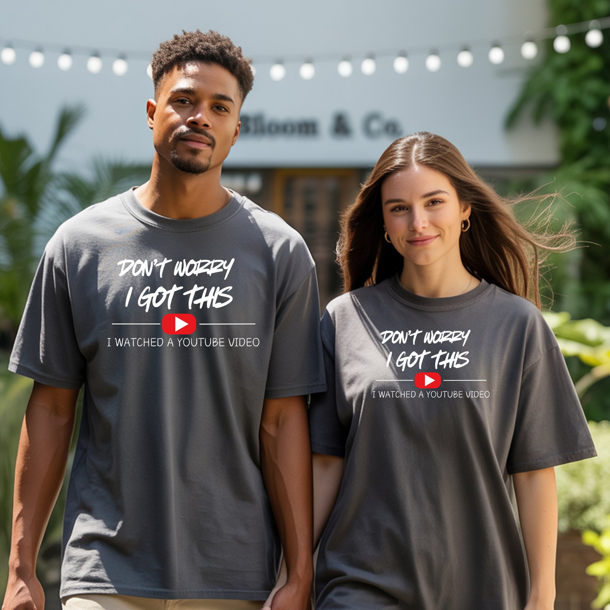 Couple wearing Funny DIY graphic T-Shirt with phrase "Don't Worry, I Got This. I Watched a YouTube Video." in casual setting.