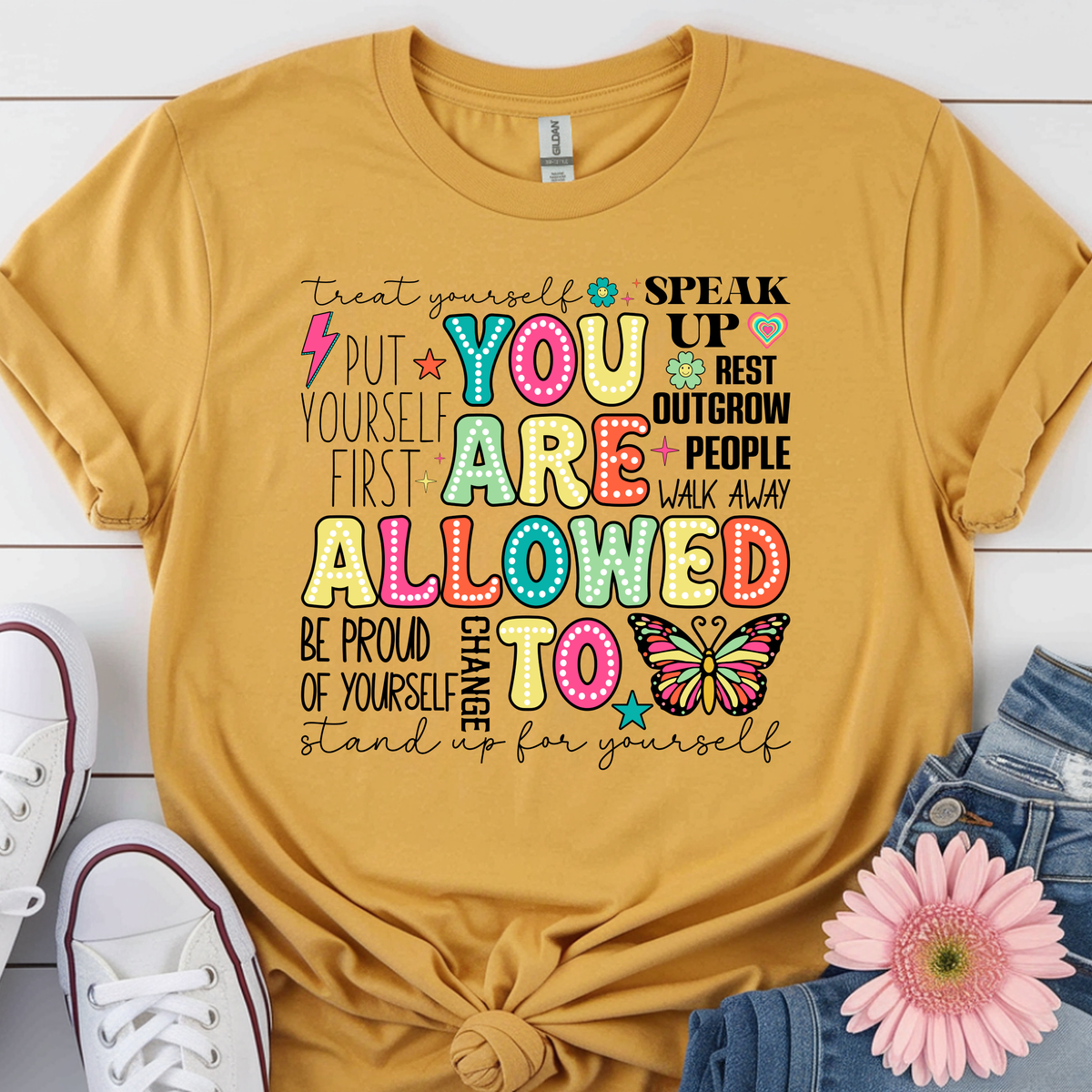You Are Allowed To graphic t-shirt in vibrant colors with positive affirmations on a yellow background.