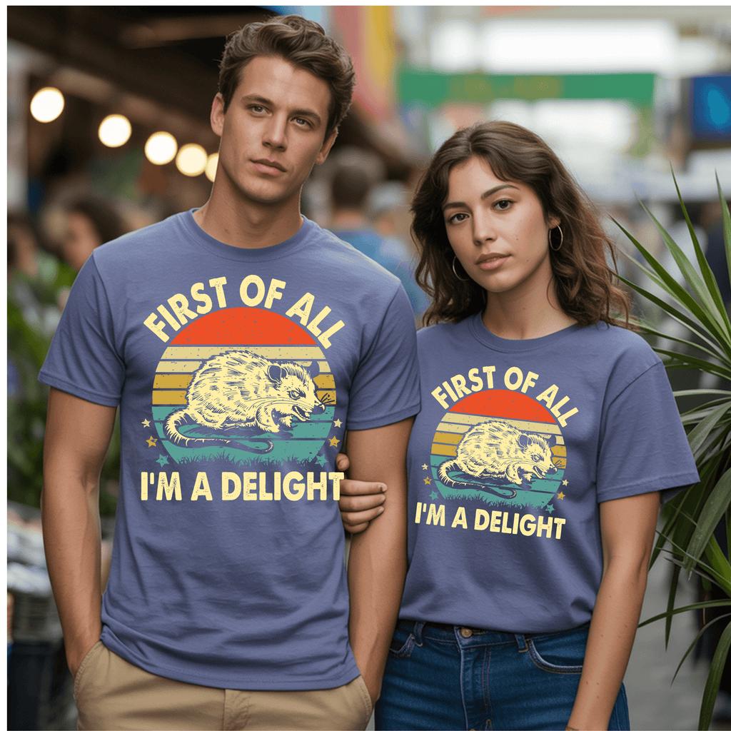 Two people wearing vintage graphic t-shirts featuring the phrase 'FIRST OF ALL I’M A DELIGHT' with an opossum design.