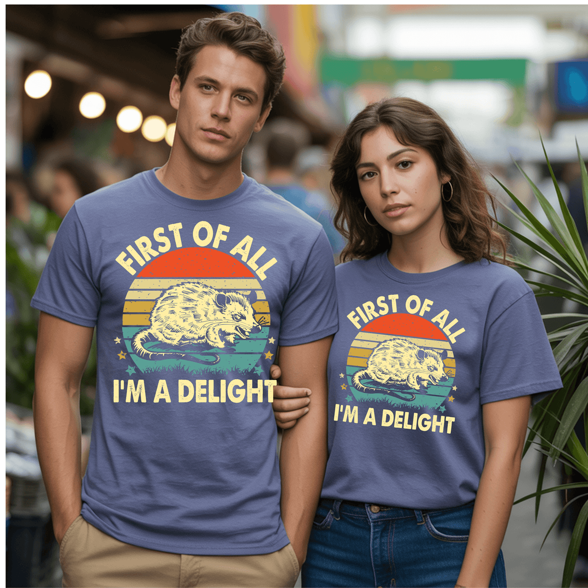 Two people wearing vintage graphic t-shirts featuring the phrase 'FIRST OF ALL I’M A DELIGHT' with an opossum design.