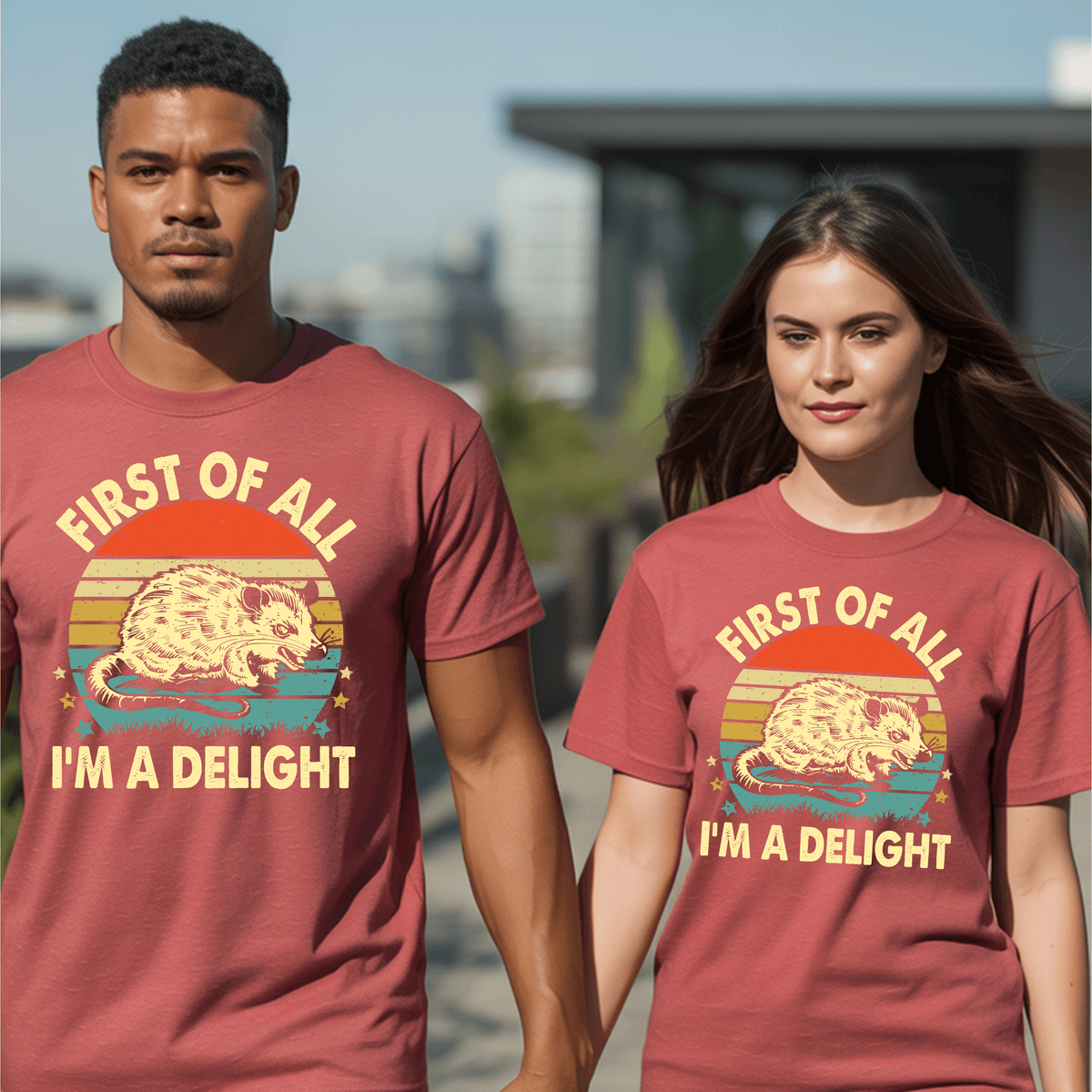 Couple wearing matching First of All I’m a Delight graphic t-shirts with opossum design and vintage sunset backdrop.